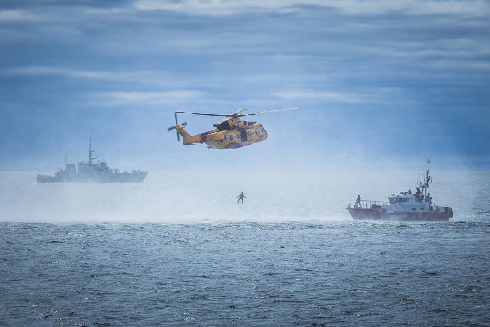 helicopter performing miltary exercise at sea